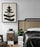 Framed sumi-e ink poster in a wood-paneled bedroom