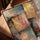 Textured modern abstract canvas in gold, pink and blue, styled above a sofa and coffee table