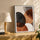 Organic abstract wall art with rounded shapes in black, brown, white, and cream