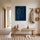 Modern minimalist line art of a woman’s face, white continuous line on dark blue, gallery‑style decor
