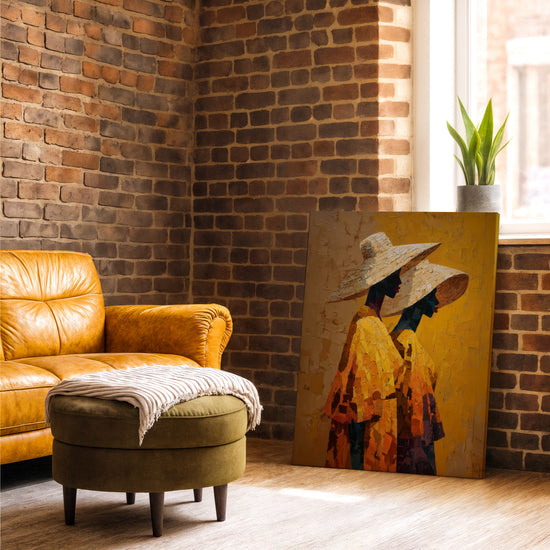 African women wall art on a brick wall with leather armchair, two women in straw hats and golden shawls, warm earthy tones