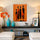 Tableau africain femmes stylisées silhouettes noires fond orange pour décoration salon minimaliste