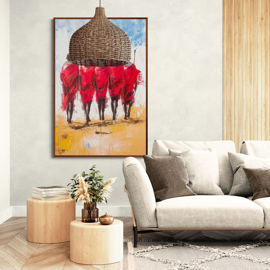 Colorful painting of Maasai warriors in red, displayed on a wall in a modern living room with a beige sofa and natural wood elements.