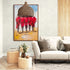 Colorful painting of Maasai warriors in red, displayed on a wall in a modern living room with a beige sofa and natural wood elements.