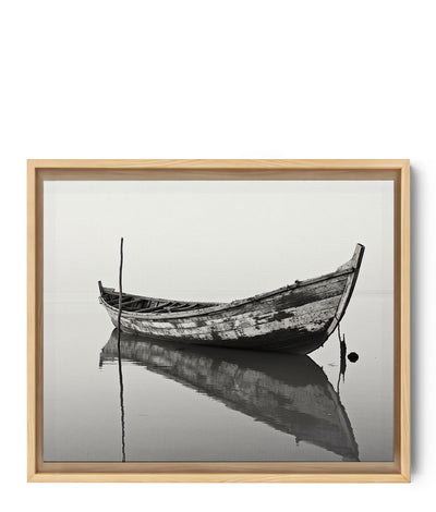 Fine art black and white photograph of a weathered rowboat on calm water with a perfect reflection; minimalist tones evoke serenity and nostalgia — ideal for zen, minimalist wall decor