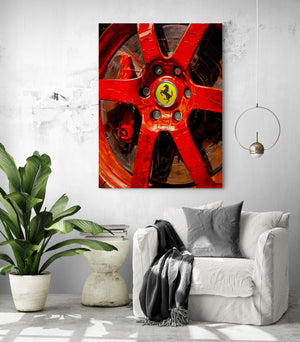 Vibrant Ferrari red painting above a white armchair, invigorating space with a green plant.