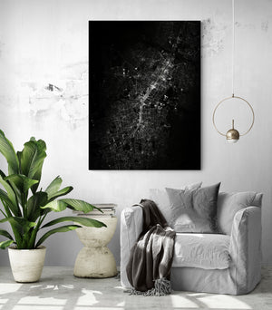 A monochrome burst of intertwined streets on the canvas creates an intriguing focal point in this neutral-toned, richly textured living room.