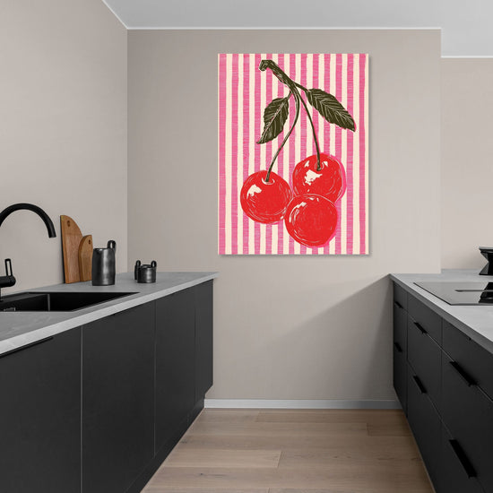 Art print featuring red cherries on pink striped background in a modern kitchen, pop art style