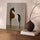 Minimalist beige and black horse canvas in a modern living room above a sideboard