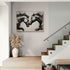 Wall art of inked black horses in a duel, modern and minimalist ambiance in an elegant foyer.