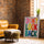 Don't Look Back colorful typography wall art on brick wall with camel leather armchair
