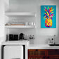un tableau original et coloré est accroché au dessus d'un évier dans une petit cuisine