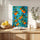 Mediterranean-style wall art of oranges and green leaves on vibrant turquoise for dining or kitchen