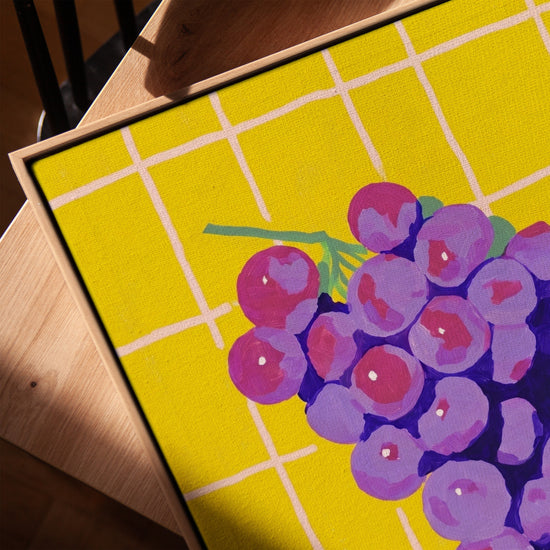 Pop art grape canvas in purple and yellow, light oak frame, contemporary living room decor