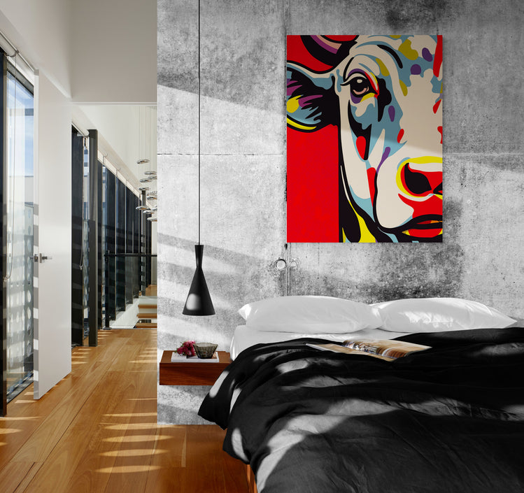 Tableau Vache coloré dans une chambre à l'ambiance industrielle et loft, contraste captivant entre le style brut et la vivacité de l'œuvre.