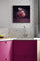 Modern kitchen decor: pink cabinets and gray mosaic tile backsplash with pink macaron and chocolate wall art