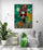 The African woman art piece enlivens a cozy corner with a gray sofa and plants.