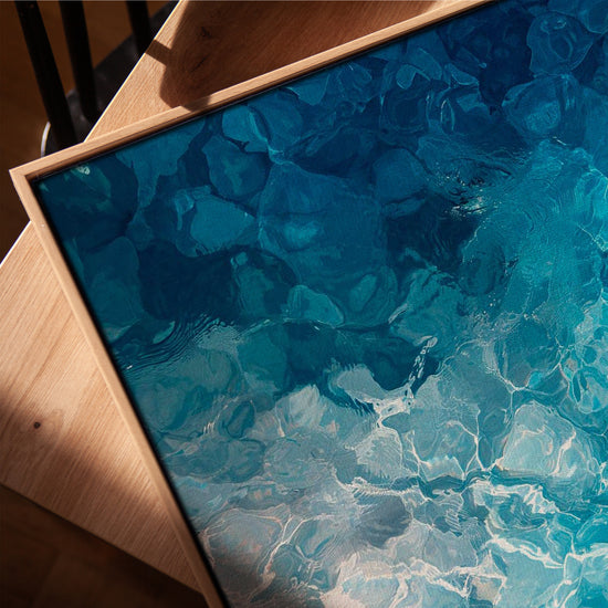 Turquoise water reflections living room wall art in a golden oak frame