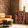 Tableau éléphant multicolore moderne touches vives pour décoration salon mur brique fauteuil cuir camel