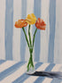 Orange and yellow flowers in a glass vase on blue and white striped background, soft modern style