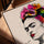 Frida Kahlo wall art with vivid pink and orange flowers, modern line art portrait in a golden oak frame for living room decor