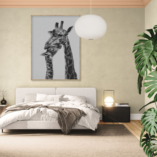 Black and white wall art of giraffes in a serene, modern bedroom, decorative wildlife art.