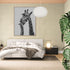 Black and white wall art of giraffes in a serene, modern bedroom, decorative wildlife art.