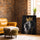 Black-and-white lion with gold crown canvas on brick wall beside leather chair