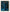 Stapel blauer und oranger Makronen auf abstraktem blau-grauem Hintergrund.