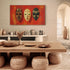ableau contemporain de trois masques africains aux couleurs ocre, jaune et vert, accroché dans une salle à manger au style ethnique chic avec mobilier en bois et déco artisanale