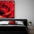 Romantic wall decor with a red rose art print above a modern bed, elegant and sensual atmosphere for the bedroom.