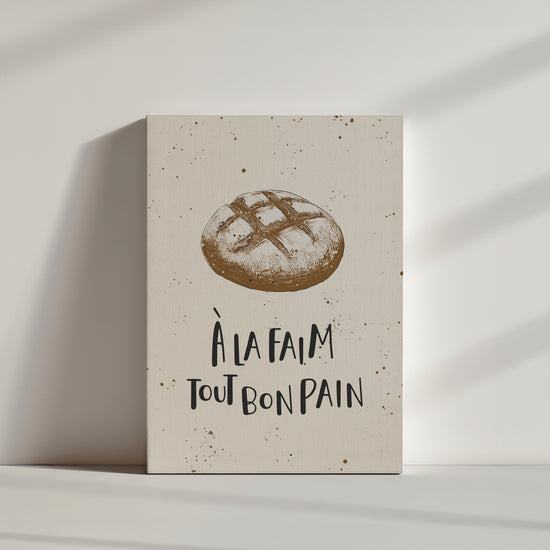 une illustration de pain de campagne sur un fond beige avec une citation, à la faim tout bon pain.