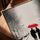Minimalist living room wall art of a couple under a red umbrella in a snowy cityscape