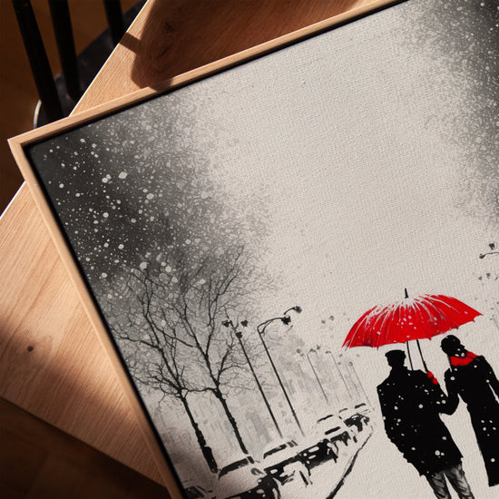 Minimalist living room wall art of a couple under a red umbrella in a snowy cityscape