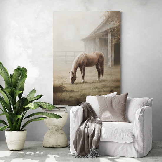 Large countryside horse painting above a white armchair; misty barn, rustic chic decor, serene atmosphere.