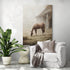 Large countryside horse painting above a white armchair; misty barn, rustic chic decor, serene atmosphere.