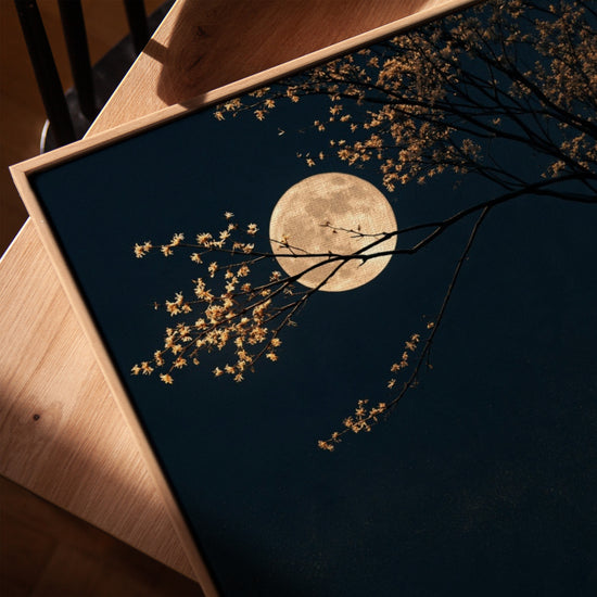 Luminous moon and flowering cherry tree wall art in an oak frame for a serene living room
