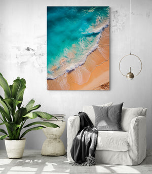 Beach wall art suspended above a white chair, creating a serene and intimate atmosphere
