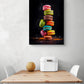 tableau décoration cuisine avec des macarons trés coloré accroché au dessus d'une table de cuisine