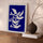 Blue and white dove canvas wall art hanging above a modern sideboard