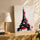 Modern Eiffel Tower canvas on oak sideboard with table lamp, black and fuchsia palette
