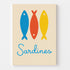 Colorful wall art with three stylized sardines, offering a playful and vintage vibe for the kitchen.