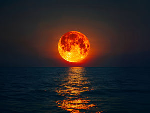 Grand painting of a glowing red moon and reflections on ocean for a mystical and serene ambiance