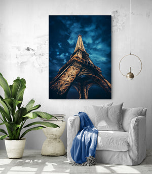 The contrast between tropical plants and the iconic image of Paris on the canvas creates a harmonious blend of nature and urban architecture.