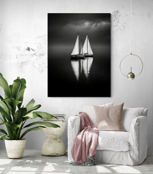 a sailboat painting hangs in a minimalist and sleek living room