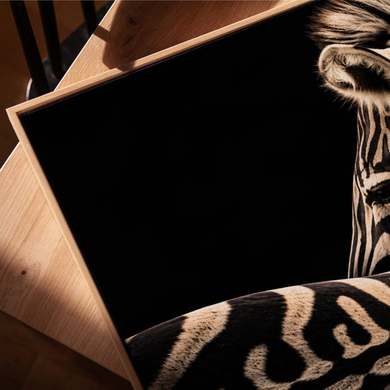 Black and white zebra canvas with gold stripes, oak-framed wall art for an elegant living room