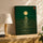 Tableau zen lune dorée sur mer émeraude dans salon moderne avec buffet chêne et lampe décorative