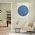 Blue circular calligraphy art on beige wall, modern style in a bright living room