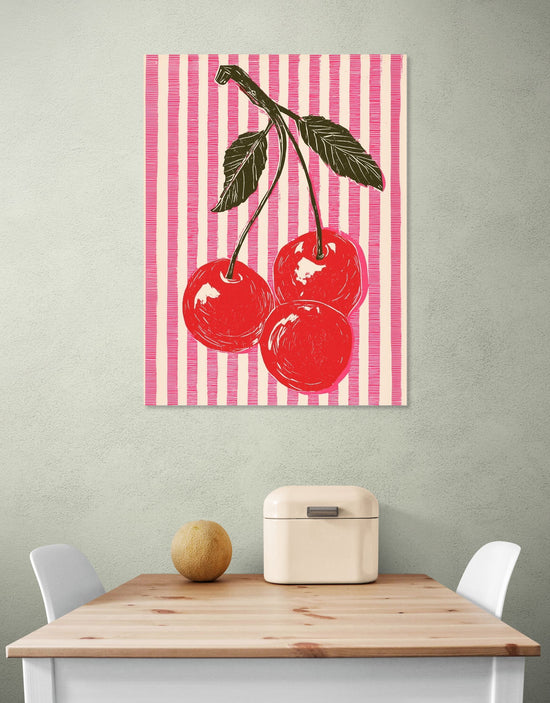 Wall art with red cherries on pink striped background, pop art style in a modern kitchen