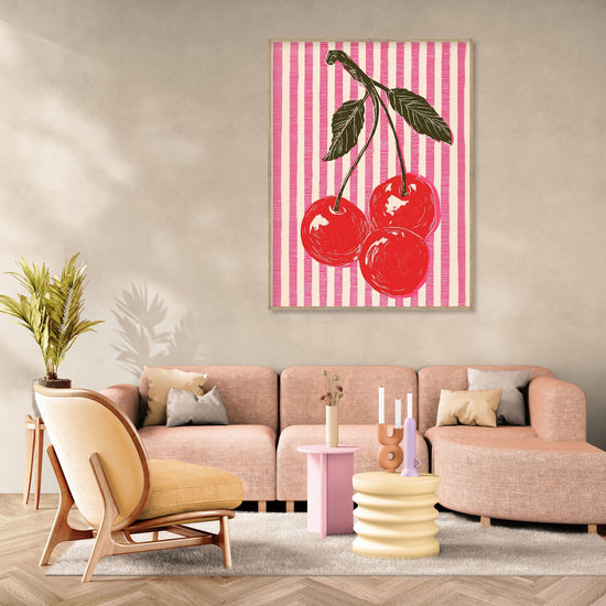 Art print of red cherries on pink striped background, vibrant pop art style in a modern living room